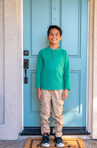boy_in_front_of_door_green_shirt.jpg